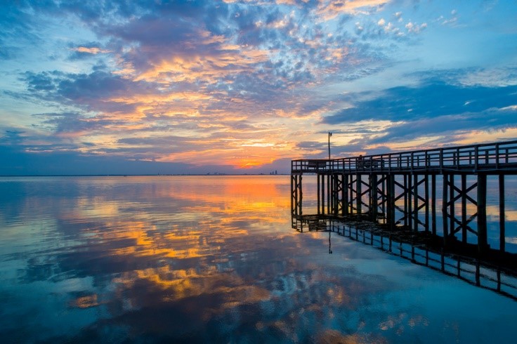 pier on the ocean with a sunset