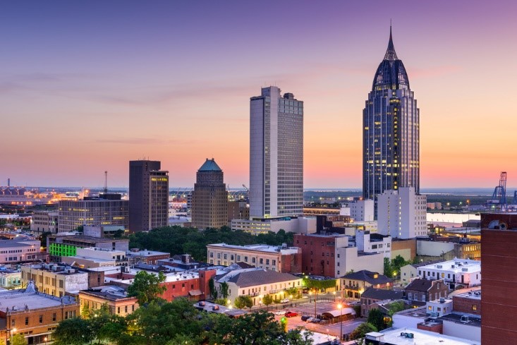 city of mobile al with skyscrapers touching the sky in the evening