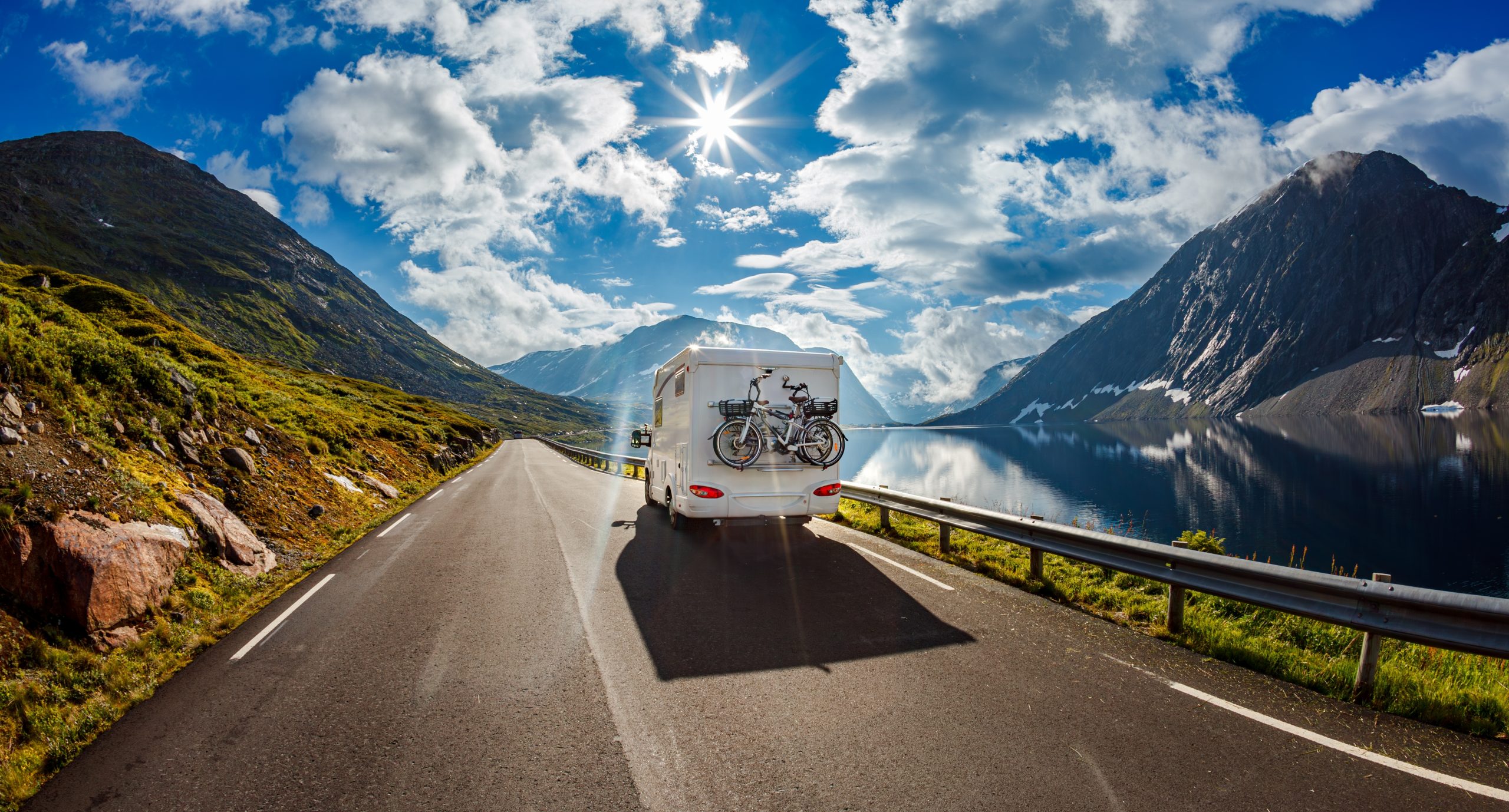 RV camping vehicle driving on a mountain road.